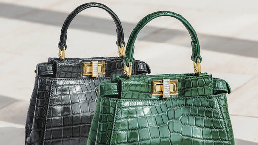 A pair of elegant handbags crafted from luxurious crocodile leather, one in a glossy black and the other in a vibrant emerald green